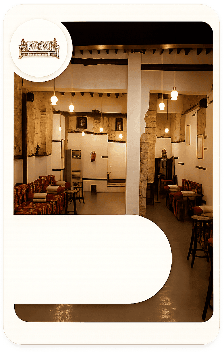 An interior majlis with heritage seating and warm lighting in Beit Al-Matbouli