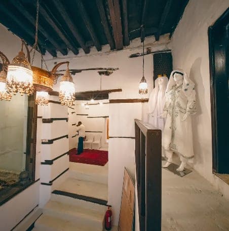 A traditional garment displayed in one of the house's rooms