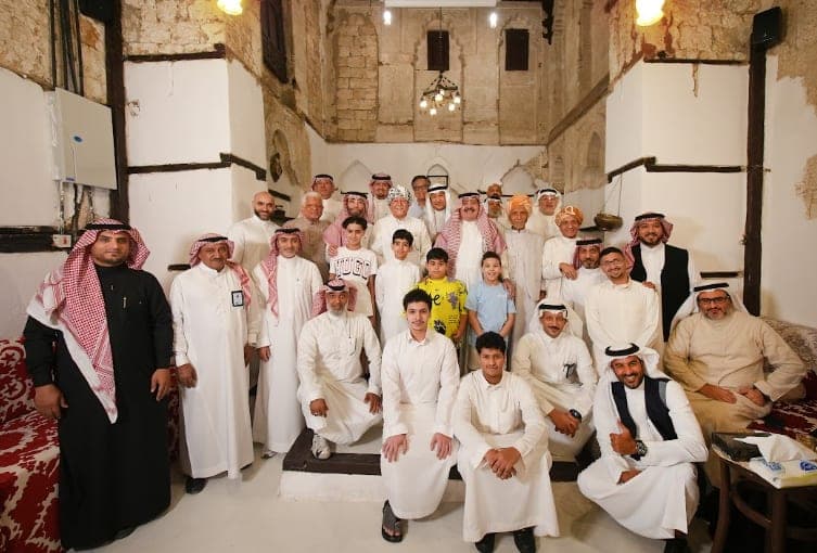 A gathering of visitors in Saudi dress in the house's majlis